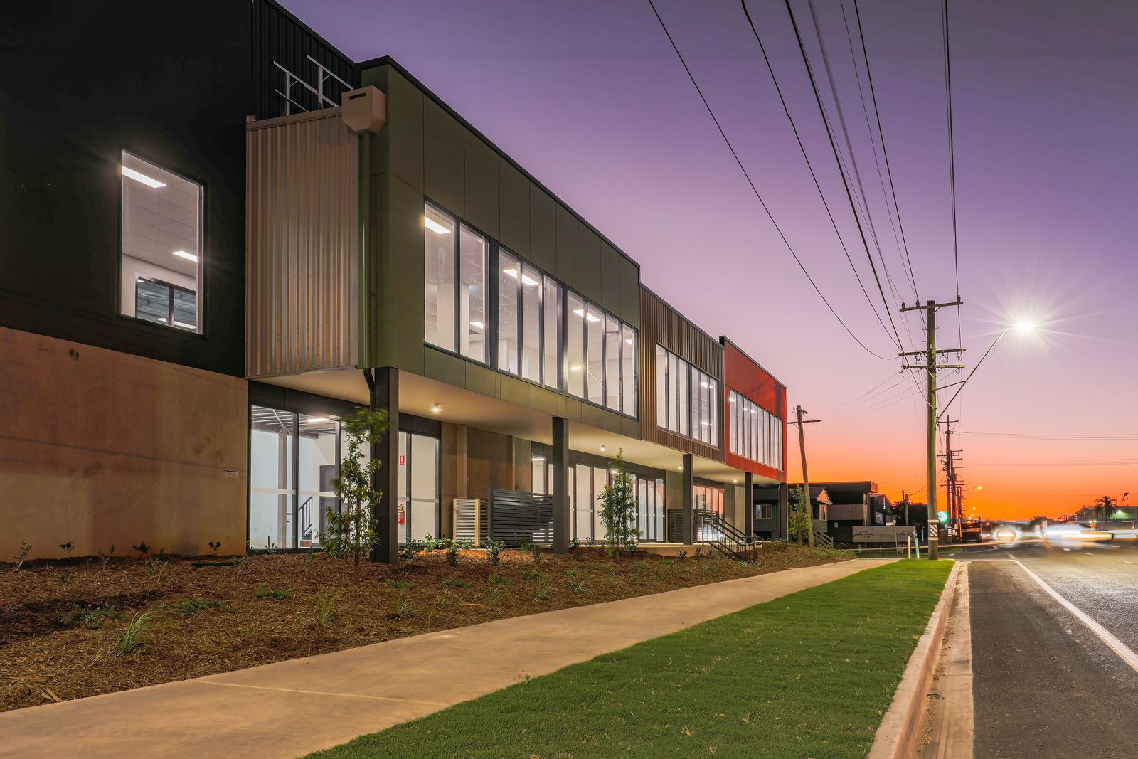 Commercial street frontage with new garden beds and footpath